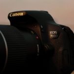 black nikon dslr camera on white table